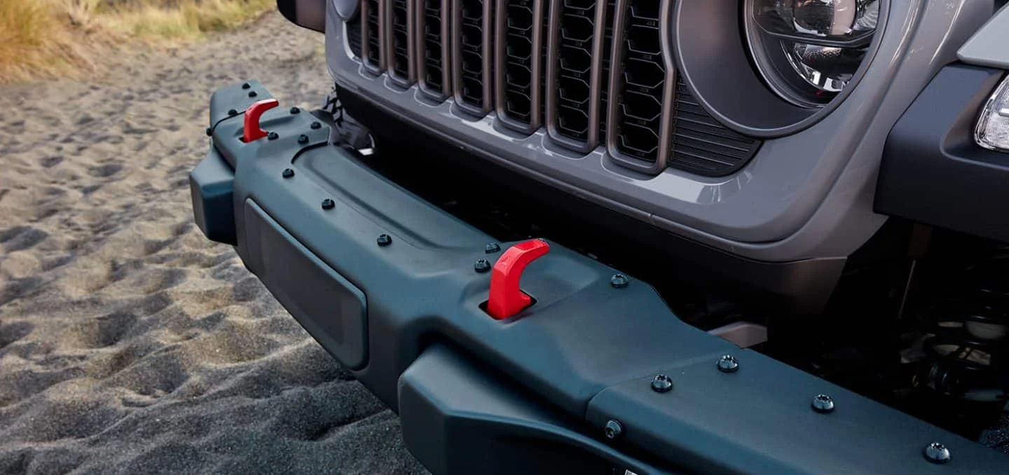 2026 Jeep Gladiator Trail Rated model splashing through water on a rocky off-road trail